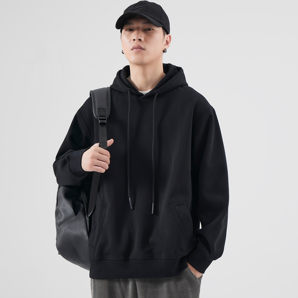 Relaxed black pullover hoodie styled with casual pants